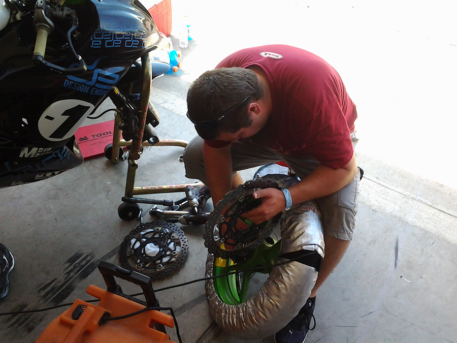 Max putting on a front rotor. The team only has one set of rotors