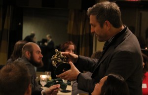 Bart looks over one of the trophies explaining that one from 2014 fell and broke and that he was going to repair it so that it rides a wheelie.