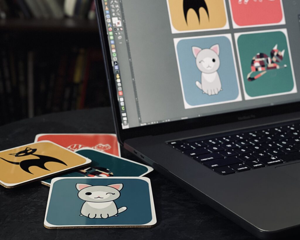 Macbook with coasters designed in Adobe Illustrator