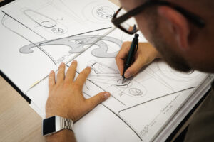 An image of an industrial designer sketching something