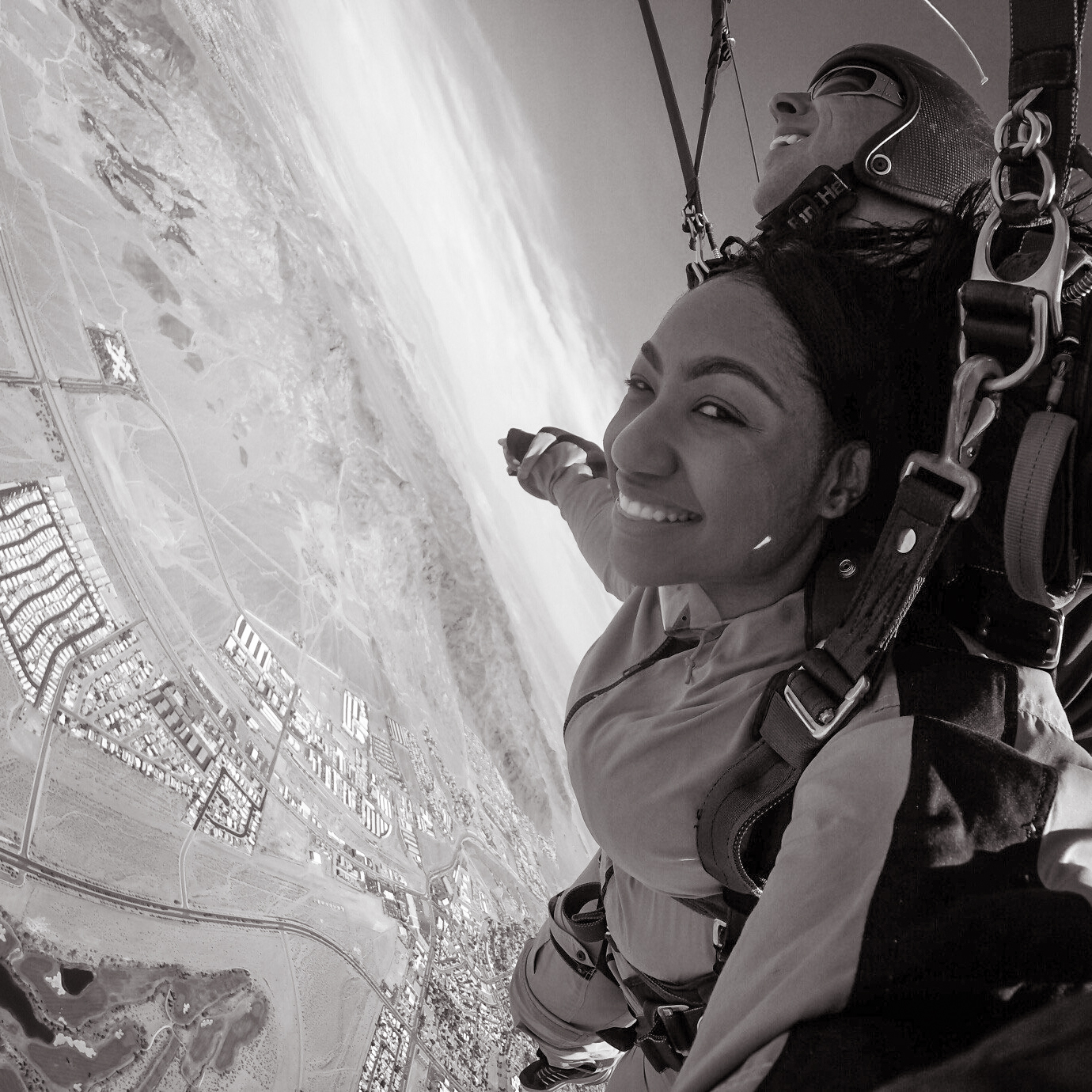 A black and white picture of a girl skydiving