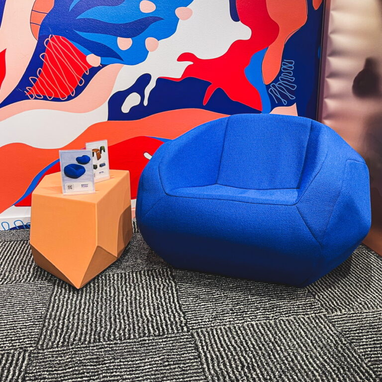 A blue and pink designer chair from the Sixinch display at NeoCon 2023