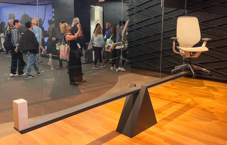 Photo of a scale with a chair and a 29lb weight from the Steelcase exhibition at NeoCon 2023