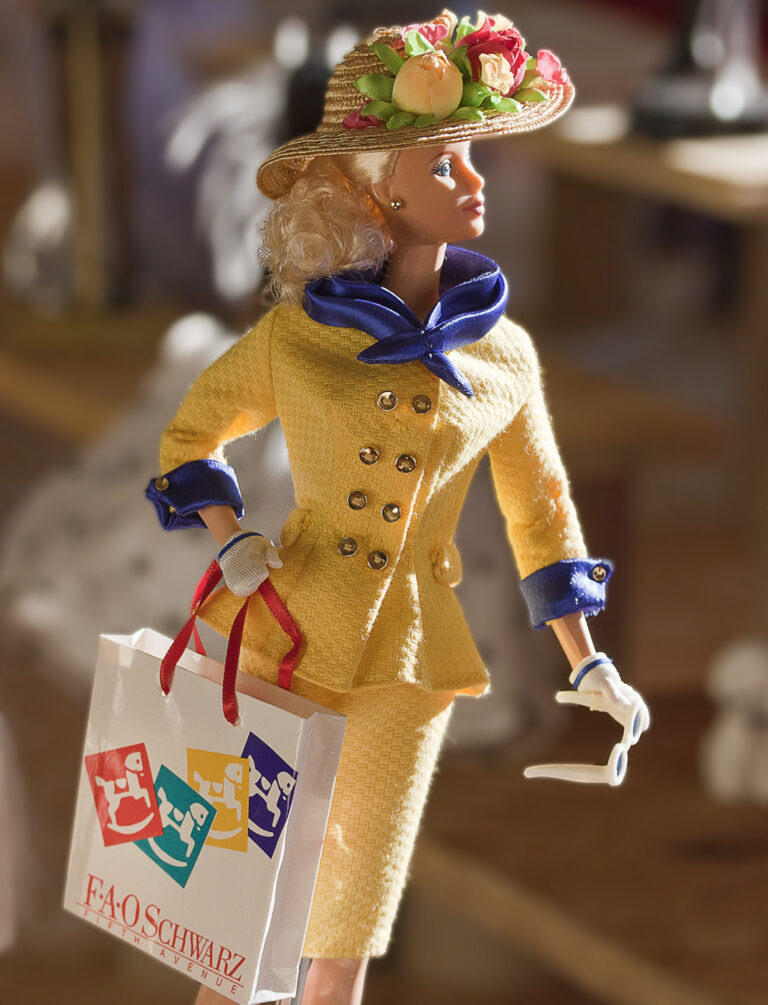 An image of Barbie shopping in a yellow designer outfit trimmed in blue. Photo by OrMa Varedo.